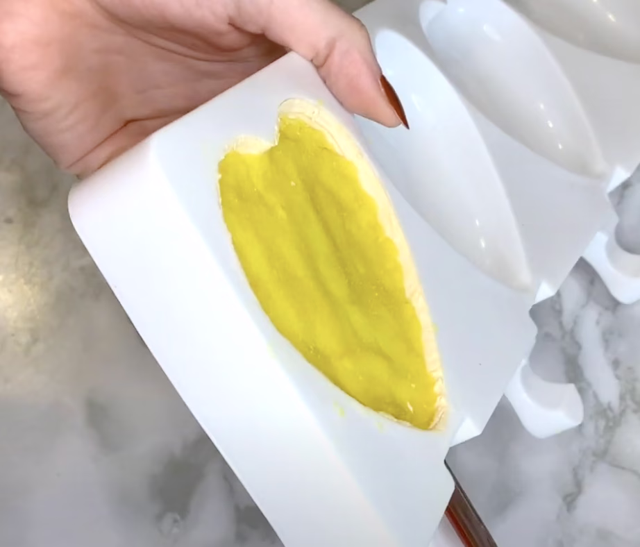 Cake filling pressed into mold with space left at the top